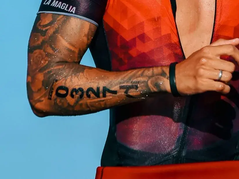 Race number temporary tattoo on a triathlete's forearm